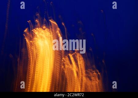 Blured abstract background with warm orange shapes and cold dark blue surroundings. Graphic resources Stock Photo