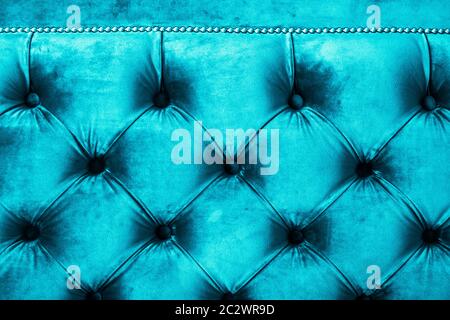 Blue luxury velour quilted sofa upholstery with buttons, elegant home decor texture and background Stock Photo