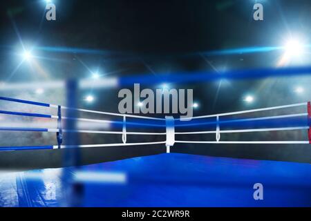 Boxing ring, closeup view through the ropes, nobody. Professional arena for sport competitions and fighting tournaments Stock Photo