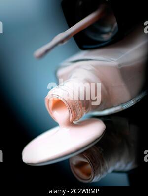 Spilled bottle of light pink nail polish Stock Photo