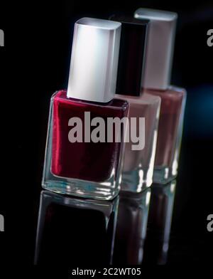 Colorful nail varnish bottles on a black background Stock Photo