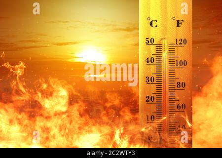 Thermometer with high temperature on the city with glowing sun background. Heatwave concept Stock Photo