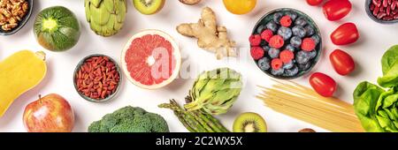 Vegan food panoramic flatlay shot. Healthy diet concept. Fruits, vegetables, pasta, nuts, legumes on a white background Stock Photo
