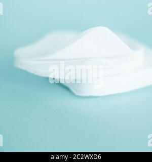Organic cotton pads on mint background, cosmetics and make-up remover, hygiene and skincare beauty brand product for healthcare Stock Photo