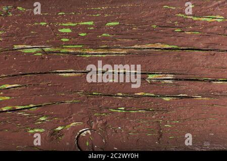Wood texture. The board is painted with brown paint. The paint is peeling from a wooden board Stock Photo