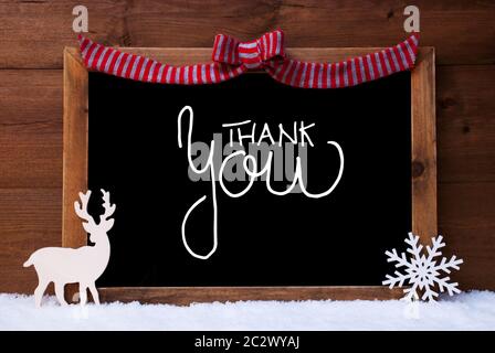 Chalkboard With English Calligraphy Thank You. Christmas Decoration Like Deer And Bow. Wooden Background With Snow Stock Photo