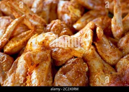 Chicken wings in a marinade. Close-up photo. Cooking chicken with spices in the oven. Grilled chicken wings recipe. Stock Photo