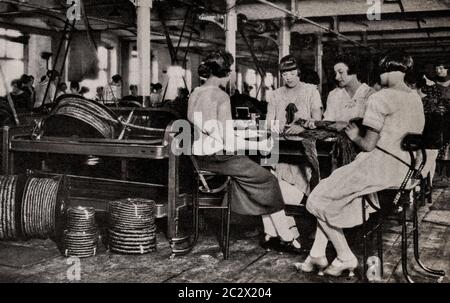 An early 1920's view of factory girls making Irish 'Twist' chewing tobacco in a Belfast factory, Ulster, Northern Ireland. Originally photographed by Clifton Adams (1890-1934) for 'Ireland: The Rock Whence I Was Hewn', a National Geographic Magazine feature from March 1927. Stock Photo