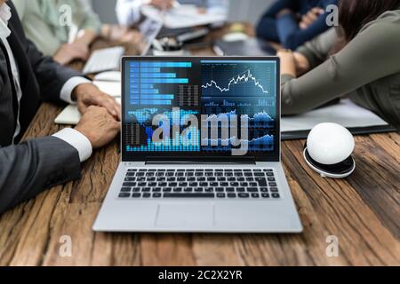 Close-up Of Male And Female Businesspeople In Meeting Discussing Graphs Stock Photo
