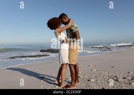 Happy couple embracing each other on the beach Stock Photo