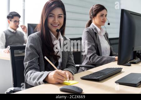Smiling call Center working Stock Photo