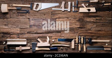 Various Carpenter Tools From Toolkit Laying On Desk Stock Photo