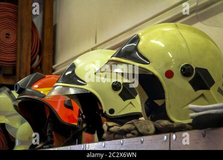 Helmets of firefighters, fire helmet are at hand parked Stock Photo