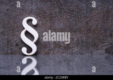 Close-up Of A Paragraph Symbol Leaning On Dark Wall