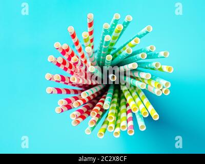 colorful paper drinking straws on blue background Stock Photo