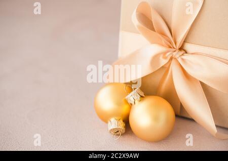 Christmas luxurious gift box with christmas balls. Elegant Christmas background with modern golden decorations. Copy space. Stock Photo