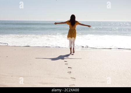 Caucasian woman standing on the beach Stock Photo