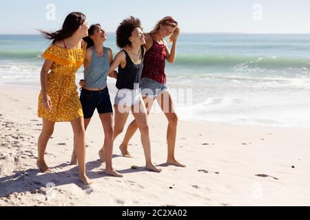 Multi-ethnic group of female standing on the beach Stock Photo