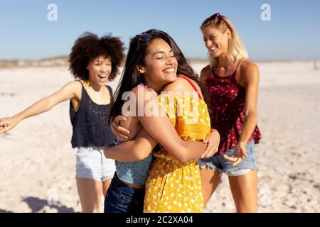 Multi-ethnic group of female standing on the beach Stock Photo