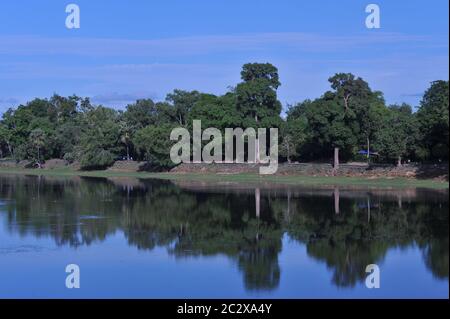 During the coronavirus pandemic, the temples of Angkor are deserted. here, the peaceful Srah Srang Reservoir / Baray awaits the return of the tourists. reflection of trees in water. Angkor Archaeological Park, Siem Reap Province, Cambodia. June 18th, 2020. © Kraig Lieb Stock Photo