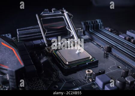 Thermal grease paste on computer processor chip. Thermal compound on on PC CPU. Cooling upgrade concept. Stock Photo