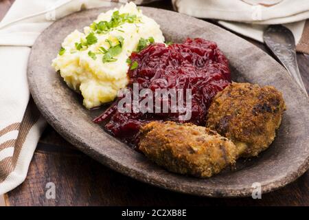 Prepared dinner on the plate. Melted meat, potatoes, beetroot Stock Photo