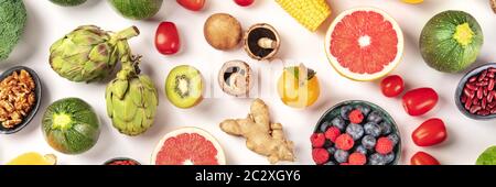 Vegan food flat lay panorama. Healthy diet concept. Fruits, vegetables, nuts, legumes, shot from the top on a white background Stock Photo