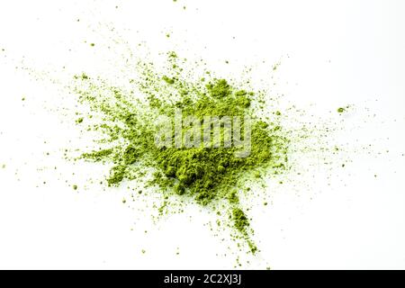 Matcha powder explosion on white background. Matcha is made of finely ground green tea powder. It's very common in japanese culture. Matcha is healthy Stock Photo