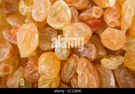 Raisins are produced in many regions of the world and may be eaten raw or used in cooking, baking, and brewing. Stock Photo
