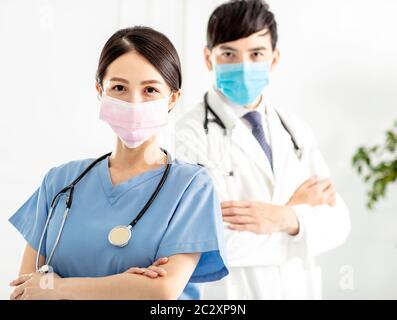 two doctors faces wearing protective mask Stock Photo