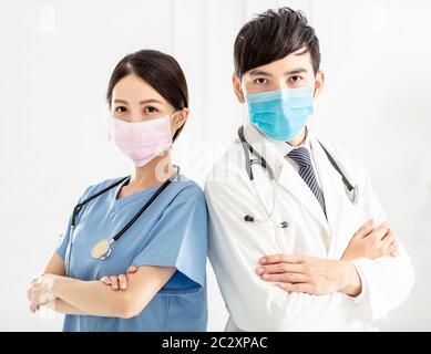 two doctors faces wearing protective mask Stock Photo