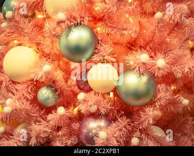 Christmas tree with gold bauble ornaments. Decorated Christmas tree closeup. Balls and illuminated garland with flashlights. New Stock Photo