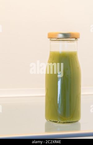 Green Smoothie in opened fridge concept. Stock Photo
