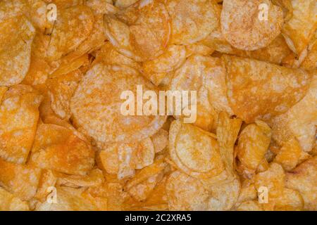 Many potato chips as a texture background. Stock Photo