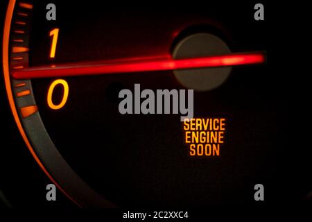 “SERVICE ENGINE SOON” light on dashboard of car in need of service or repair Stock Photo