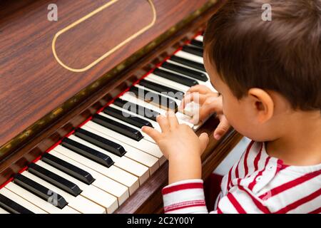 Litlle boy playing the piano Stock Photo