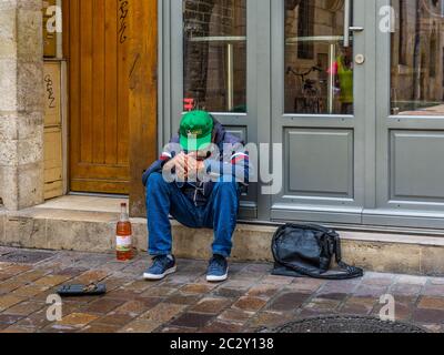 Man with bottle of wine begging in centre of Tours, France. Stock Photo