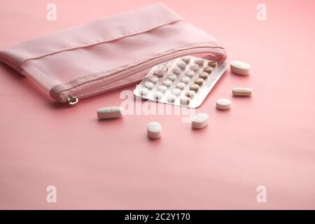 birth control pills on pink background with copy space  Stock Photo