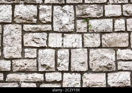 Background from a wall made of block shaped old natural stones Stock Photo