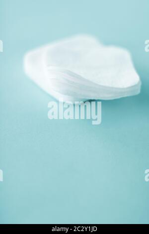 Organic cotton pads on mint background, cosmetics and make-up remover, hygiene and skincare beauty brand product for healthcare Stock Photo