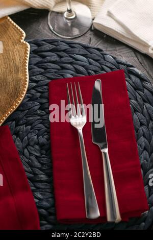 Holiday table setting with red napkin and silver cutlery, food styling props, vintage set for wedding, event, date, party or lux Stock Photo