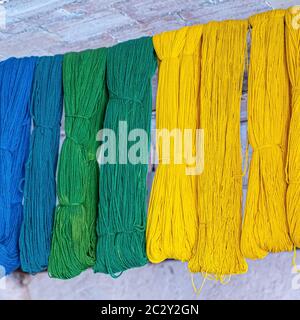 wools and yarns colored from blue to orange at the shows Stock Photo