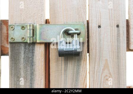 Padlock on a deadbolt gate in a garden close-up Stock Photo