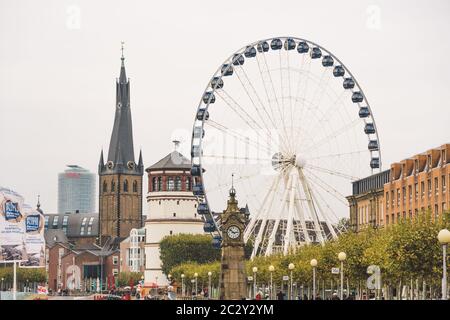 25 October 2018 Germany, Dusseldorf. North Rhine. City center, the embankment of the river. Saray Town Hall and the Ferris Wheel Stock Photo