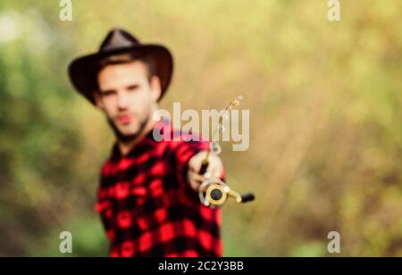 Proper fishhook. Hook and bait. Fishing hobby. Guy in cowboy hat fishing  equipment nature background defocused. Hipster fisherman hold rod spinning  selective focus. Hope for nice fishing. Fishing day Stock Photo 