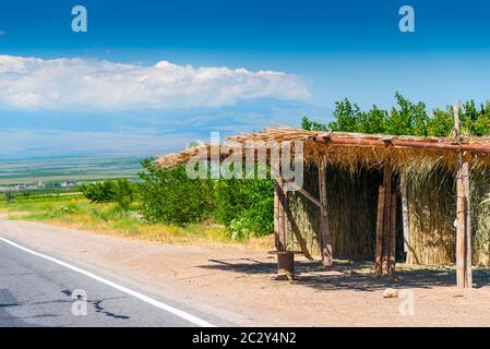 Thatched canopy from the sun on the highway of Armenia Stock Photo