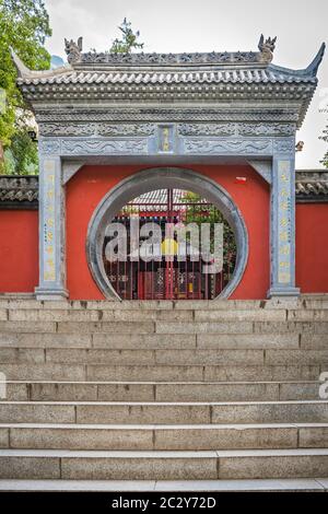 Huashan, China -  August 2019 : Wide stone concrete stairs leading to the entrance gate of the Buddhist temple at the foot of Huashan mountain, Xian, Stock Photo