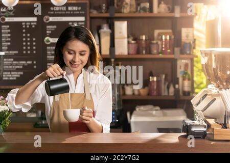 Female barista making coffee Stock Photo