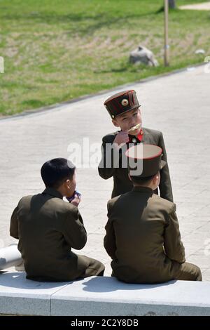 Pyongyang, North Korea - May 1, 2019: Group of the  young boys dressed in uniform of the korean people army on the Pyongyang street Stock Photo