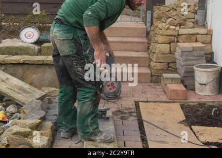 Reworking with technology Tile cutting with an angle grinder Stock Photo